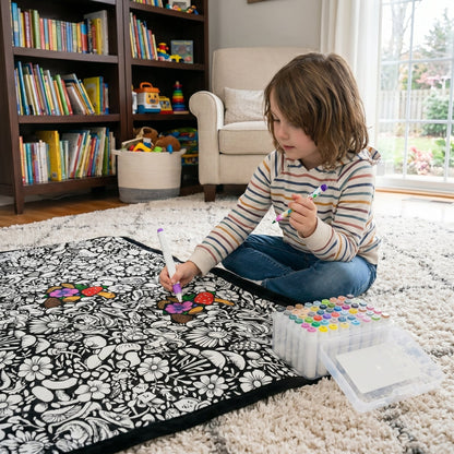 Close-up of a kid filling in a design on the coloring blanket