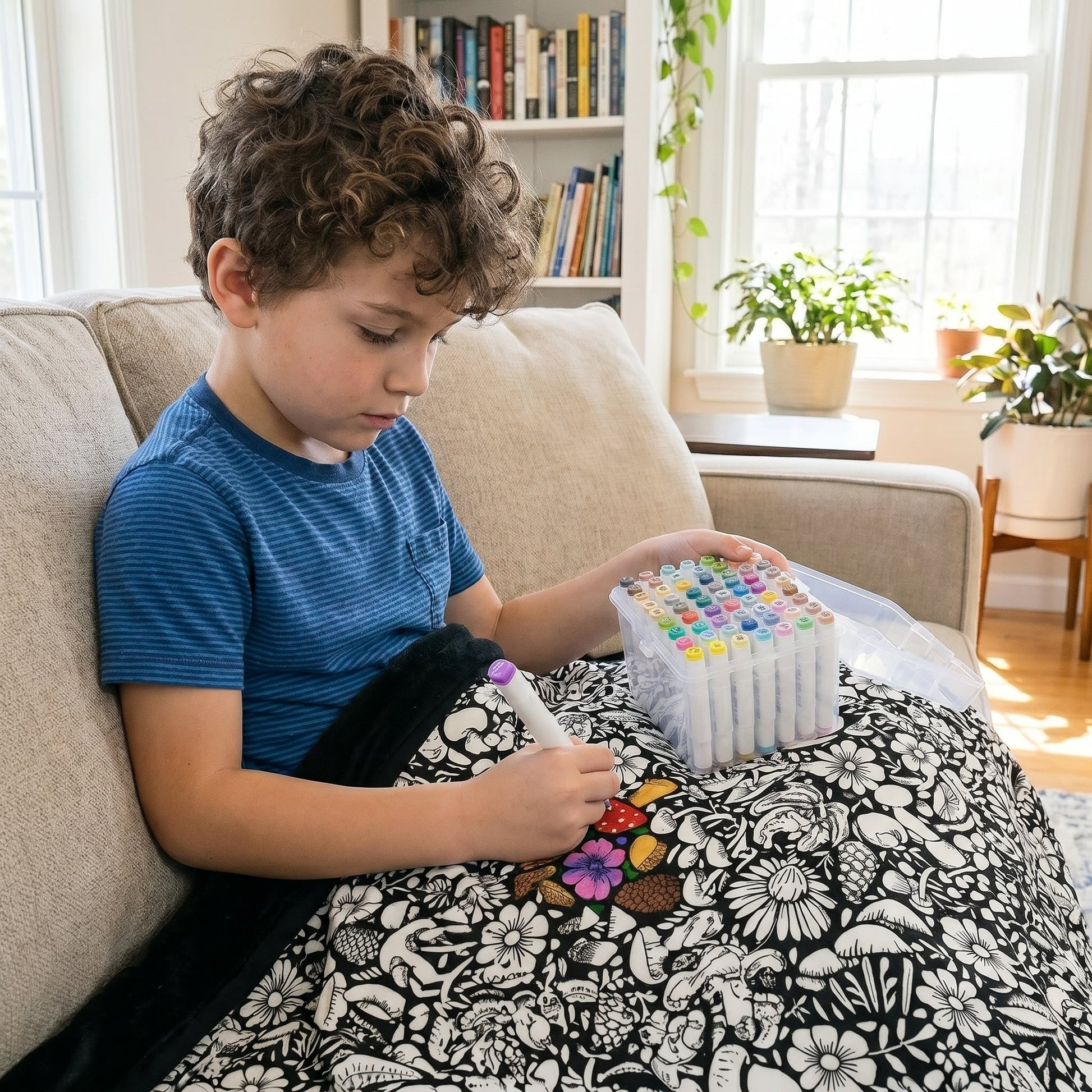 Child coloring a DIY blanket with washable markers